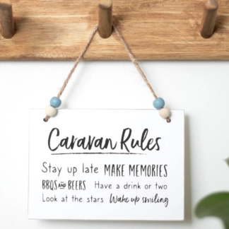 Caravan Rules hanging MDF sign with twine and blue‑white beads.